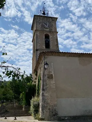 a tower with a clock on top of a building at Room in Medieval Cereste in Céreste