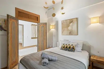 a bedroom with a large bed with a wooden headboard at Big Modern Villa Ste Victoire 10min CityCenter Aix in Saint-Marc-Jaumegarde