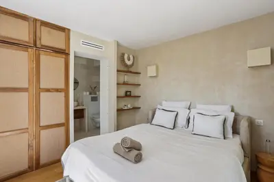 a bedroom with a white bed with two hats on it at Big Modern Villa Ste Victoire 10min CityCenter Aix in Saint-Marc-Jaumegarde