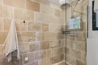 a bathroom with a shower with a glass door at Big Modern Villa Ste Victoire 10min CityCenter Aix in Saint-Marc-Jaumegarde