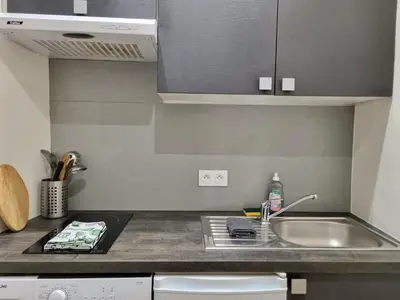 a kitchen with a sink and a counter top at Appartement climatisation centre historique in Aix-en-Provence