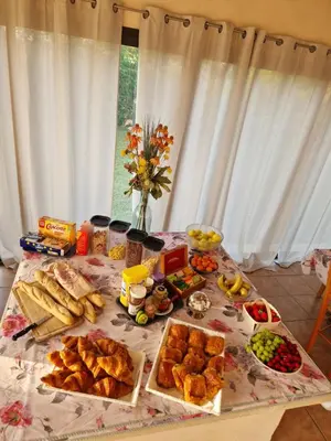 a table with a bunch of different types of food at Hôtel PRATO PLAGE in Pernes-les-Fontaines