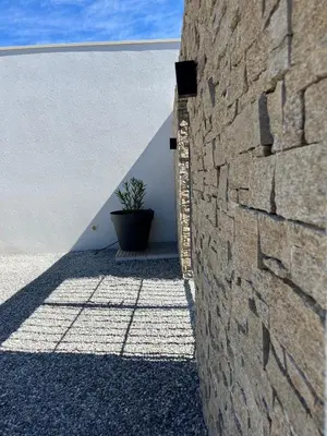 a stone wall with a potted plant next to it at La Réserve Villa in Aix-en-Provence