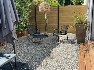 a group of chairs and a table in a yard at La Réserve Villa in Aix-en-Provence