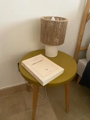 a book on a table with a lamp on it at Villa Augustine in Ventabren