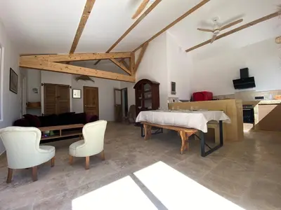 a large living room with a table and chairs at Villa Augustine in Ventabren