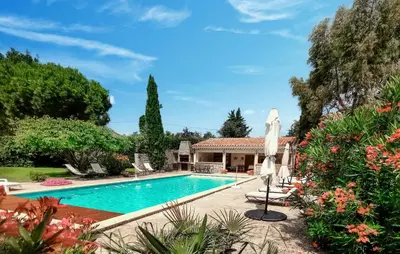 a swimming pool in a yard with a house at Nice Home In Carpentras in Carpentras