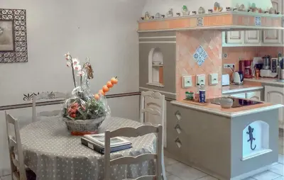 a kitchen with a table and a doll house at Nice Home In Carpentras in Carpentras