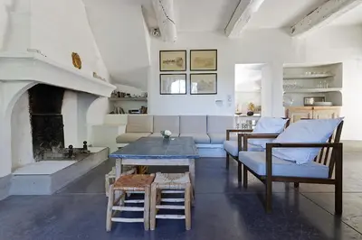 a living room with a couch and a table at La Grande Bastide in Vaugines