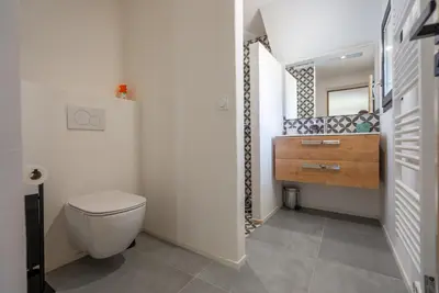 a bathroom with a toilet and a sink at Evasion Luberon in Murs
