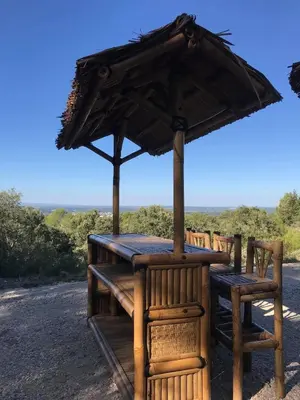 a table and chairs with an umbrella at Gîte 33 ha Piscine Activités Vue in Saumane-de-Vaucluse