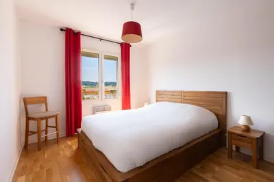 a bedroom with a bed and a window with red curtains at Universo private pool and large garden in Pernes-les-Fontaines