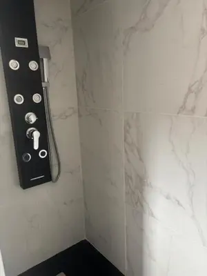 a bathroom with a remote control on the wall at Universo private pool and large garden in Pernes-les-Fontaines