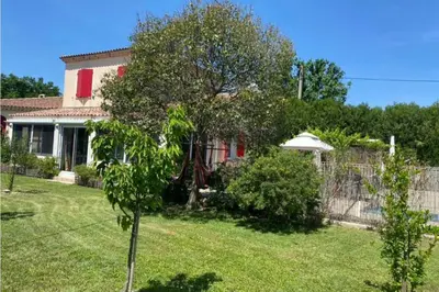 a house with a tree and an umbrella in a yard at Universo private pool and large garden in Pernes-les-Fontaines