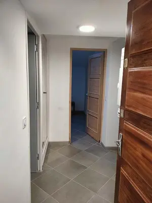 an empty hallway with a door and a tile floor at GitesLuberon 2 F2 in Charleval