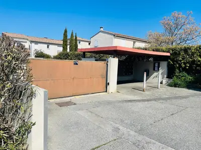a house with a gate and a fence at Apartment with beautiful terrace in LʼIsle-sur-la-Sorgue