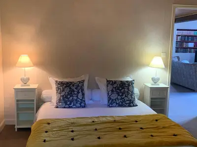 a bedroom with a bed with pillows and two lamps at Villa CHATEAU SAINTE BARBE in Loriol-du-Comtat