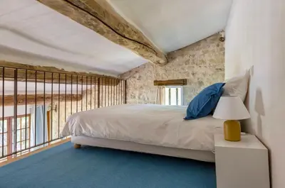 a bedroom with a bed and a large window at Maison de James in Murs