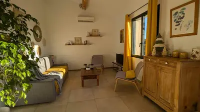 a living room with a couch and a table at Gîte le Micocoulier in Carpentras