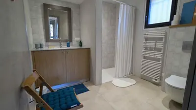 a bathroom with a toilet and a sink and a mirror at Gîte le Micocoulier in Carpentras
