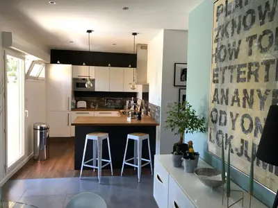 a kitchen with a island with two bar stools at Évasion Provençale in Aix-en-Provence