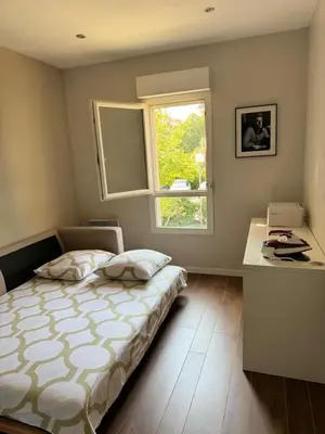 a bedroom with a bed and a window and a desk at Évasion Provençale in Aix-en-Provence