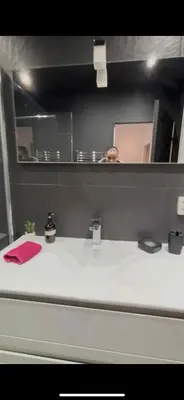 a person taking a picture in a bathroom mirror at Évasion Provençale in Aix-en-Provence