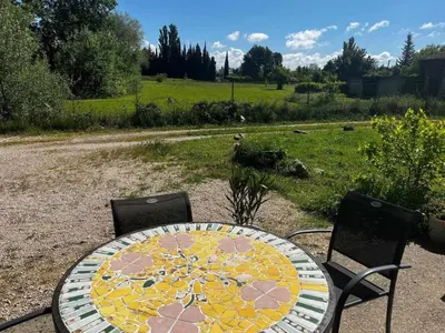 a table and two chairs with a table and a table and chairs at Gîte The Butterfly - 1 bedroom and mezzanine in Monteux