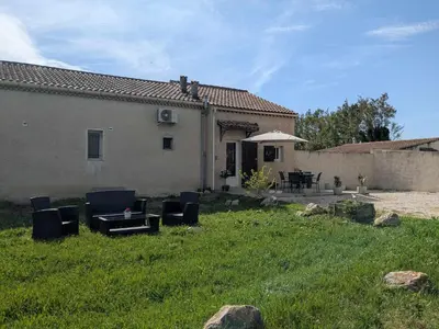 a house with chairs and a table in a yard at Gîte The Butterfly - 1 bedroom and mezzanine in Monteux
