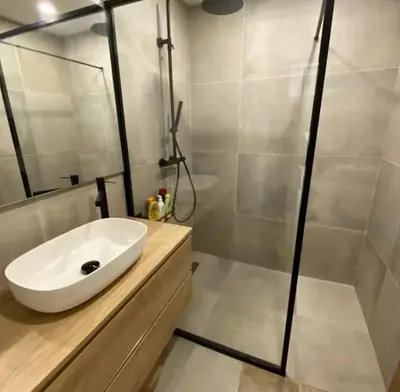 a bathroom with a white sink and a shower at Villa avec vue sur le pilon du roi in Aix-en-Provence