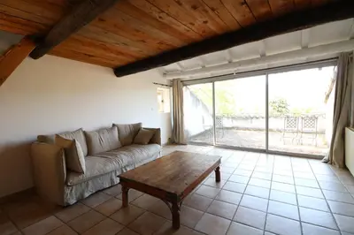 a living room with a couch and a table at Les 2 voûtes - Mas provençal pour 10 personnes in Oppède