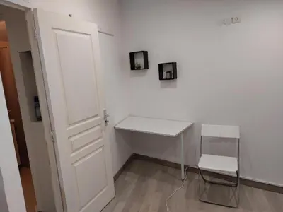 a white room with a white desk and a chair at Studio à louer sur Miramas in Miramas