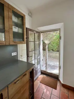 a kitchen with a door leading to a yard at Villa climatisée avec piscine in Gordes