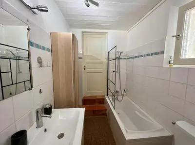 a white bathroom with a sink and a tub and a shower at Villa climatisée avec piscine in Gordes