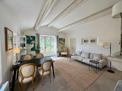 a living room with a table and a couch at Villa climatisée avec piscine in Gordes
