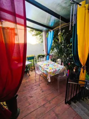 a patio with a table and chairs and a tent at Chez Nine, chambre indépendante avec terrasse in Sénas