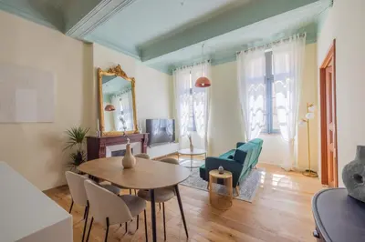 a living room with a table and chairs at Appartement Belle lettre 4 in Aix-en-Provence