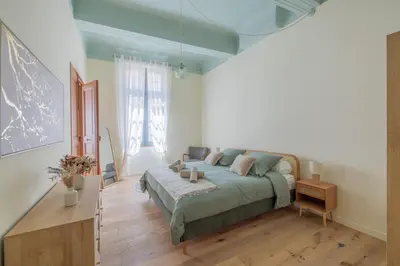 a bedroom with a bed and a table in it at Appartement Belle lettre 4 in Aix-en-Provence