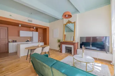 a living room with a couch and a table at Appartement Belle lettre 4 in Aix-en-Provence