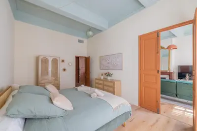 a bedroom with a large bed and a bathroom at Appartement Belle lettre 4 in Aix-en-Provence