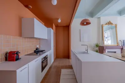 a kitchen with white cabinets and a sink at Appartement Belle lettre 4 in Aix-en-Provence