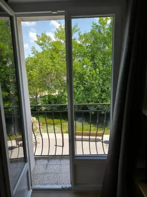 an open door to a balcony with a view at La maison du quai in LʼIsle-sur-la-Sorgue