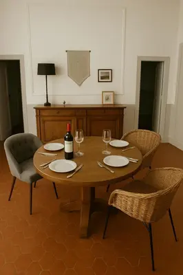 a wooden table with chairs and a bottle of wine at Inactif in Aix-en-Provence