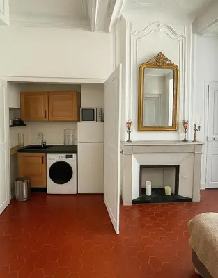 a kitchen with a counter and a sink and a mirror at Inactif in Aix-en-Provence