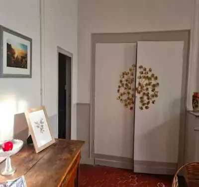 a room with a refrigerator and a wooden table at Inactif in Aix-en-Provence