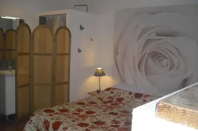 a bedroom with a bed with a white bedspread at Lou mas li Pitchoun 