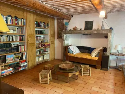 a living room with a couch and a table at La Maison Rose I Maison de village familiale in Lagnes