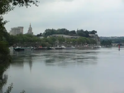 a view of a river with a city in the background at PROVENCE VAUCLUSE VELLERON Superbe maison avec piscine tout confort in Velleron