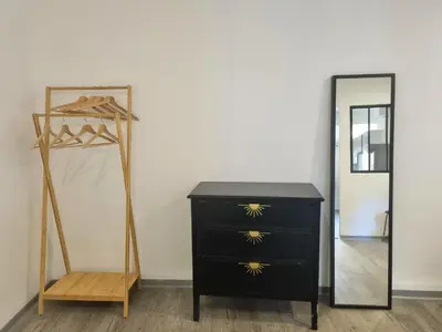 a dresser and a mirror next to a dresser at Renovated 2-room apartment in historic center in Aix-en-Provence