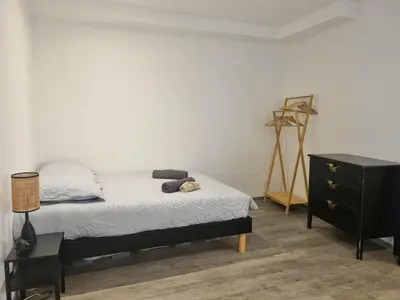 a bedroom with a bed with a dresser and a tripod at Renovated 2-room apartment in historic center in Aix-en-Provence